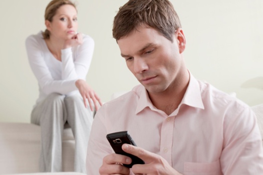 sad-woman-looking-at-man-using-phone